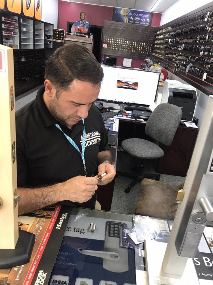 Armstrong Locksmith technician rekeying a residential door lock in Nashville TN
