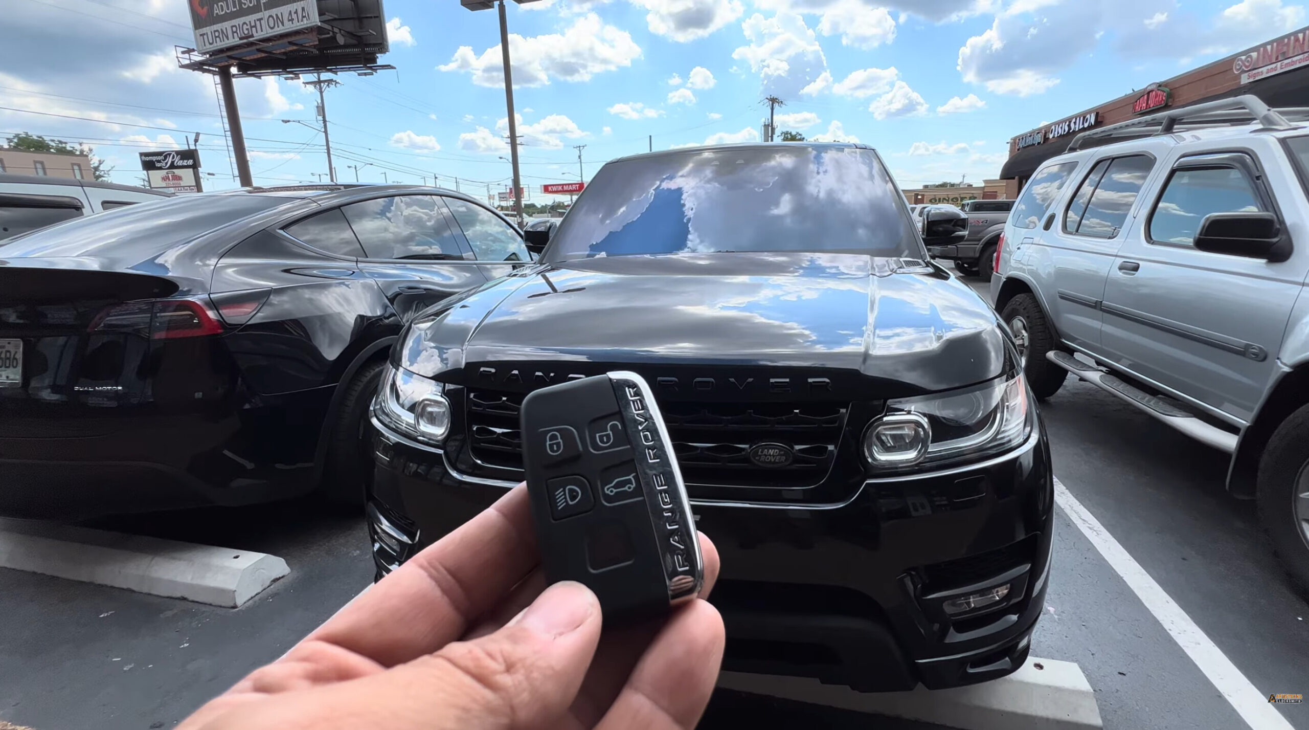 Technician Rahim holding a newly programmed 2017 Land Rover smart key onsite
